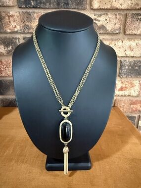 Gold tone toggle front closure necklace with Black double sided tassel pendant